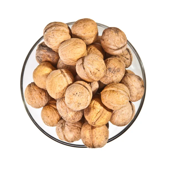 Walnuts in a glass dish on a white background — Stock Photo, Image