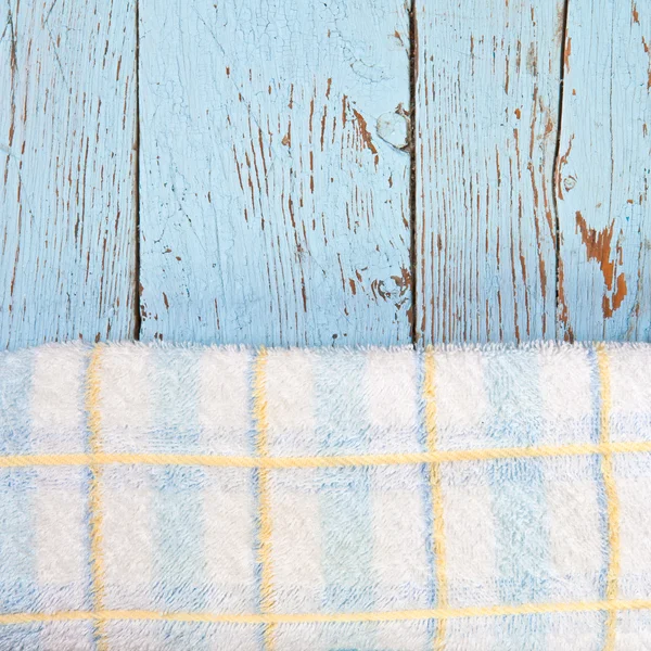 Checkered towel on wooden boards background — Stock Photo, Image