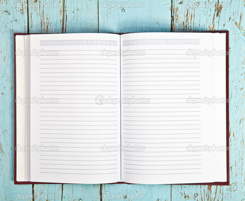 Open notebook on a wooden background
