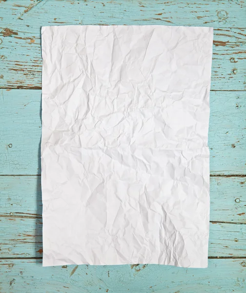 Crumpled sheet of white paper on the wooden background — Stock Photo, Image