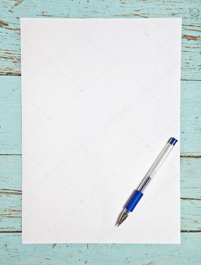 Sheet of white paper and a pen on a wooden background
