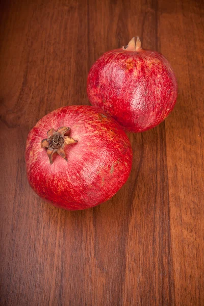 Pomegranate on wooden background — Stock Photo, Image