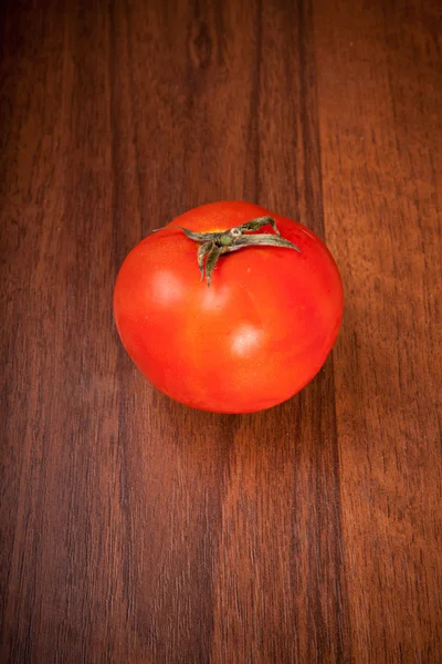 Tomato on a wooden background — Stock Photo, Image