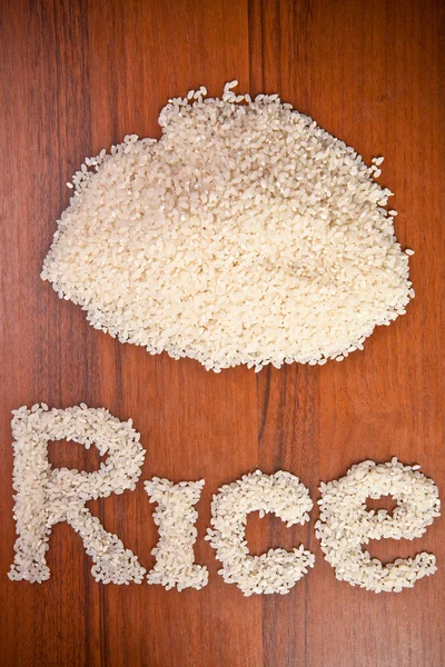 Słowo ziaren ryżu na tle drewniane — Zdjęcie stockowe