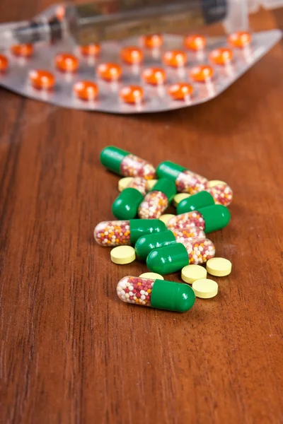 Pills on a wooden background — Stock Photo, Image