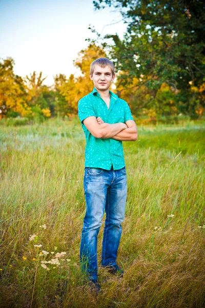 genç adam bir çayır-kollarını ile ayakta katlanmış