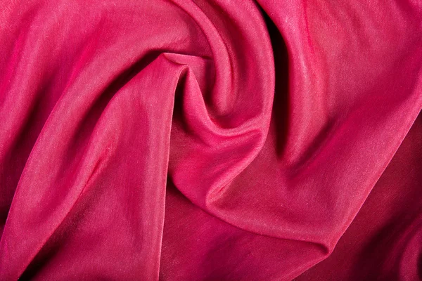 Fundo têxtil vermelho com dobras — Fotografia de Stock