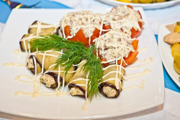 Stuffed tomatoes and eggplant rolls on the table — Stock Photo, Image