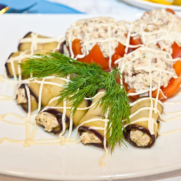 Stuffed tomatoes and eggplant rolls on the table — Stock Photo, Image