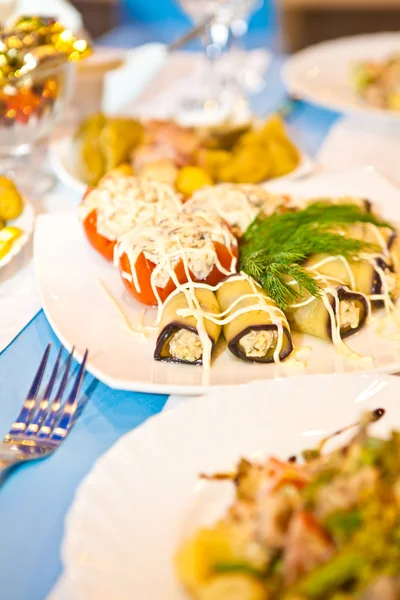 Stuffed tomatoes and eggplant rolls on the table — Stock Photo, Image