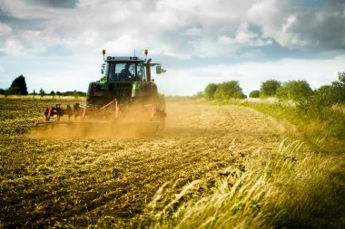 Tractor ploughs field clipart