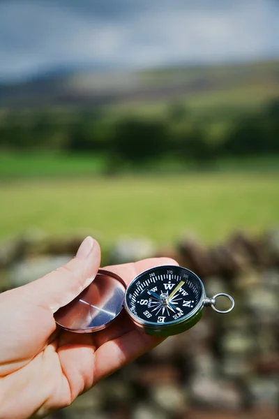 Hand Holding Compass in Rural Setting — Stock Photo, Image