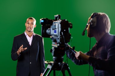Presenter in studio with TV camera and Camera Operator clipart