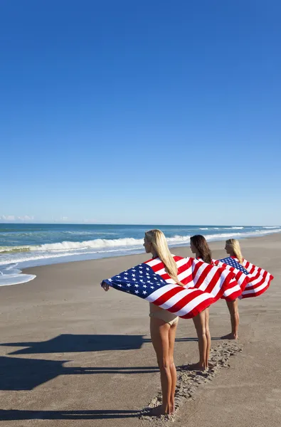 Three Young Women Wrapped in American Flags on a Beach — Stock Photo, Image