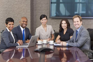 Interracial Men & Women Business Team Meeting in Boardroom clipart