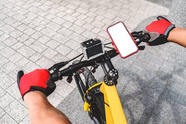 Model, akıllı telefon. Bir bisikletin gidonunda.