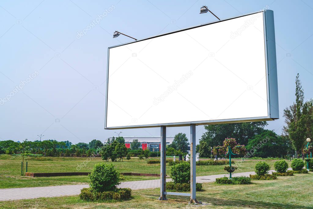 Blank billboard mockup with white screen. Against the backdrop of nature and blue sky. Business concept. Copy space banner for advertising