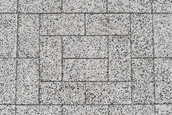 Yakın çekim, doku, arka plan. Granit bir kırıntıdan dikdörtgen döşeme levhaları