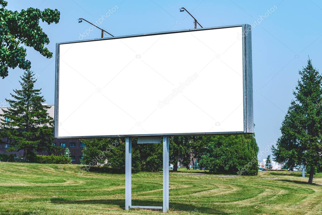 Blank billboard mockup with white screen. Against the backdrop of nature and blue sky. Business concept. Copy space banner for advertising