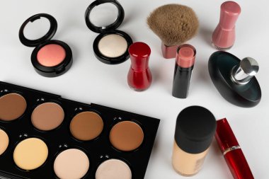 Makyaj ürünlerinin ve aksesuarların, kontur paletinin, beyaz arkaplanda fırçaların resmini kapat 