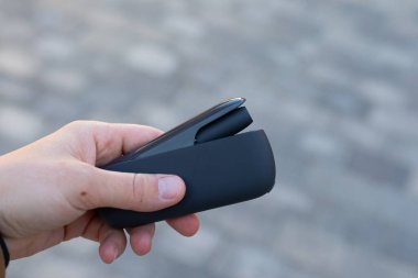 Elektrikli sigara tutan bir adamın resmi.