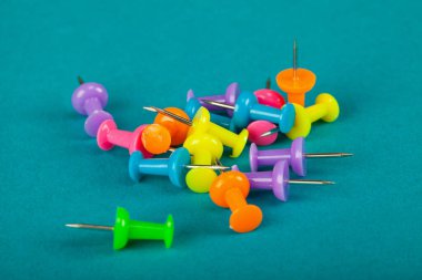 Colourful thumbtack pins on a blue background