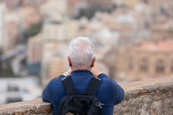 Old man taking picture in Malaga , Spain