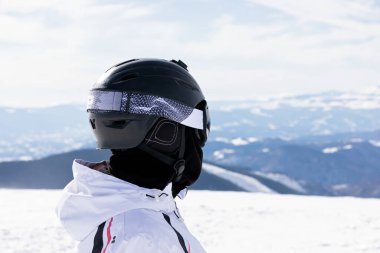 Head shot of woman skier  wearing ski helmet and goggles