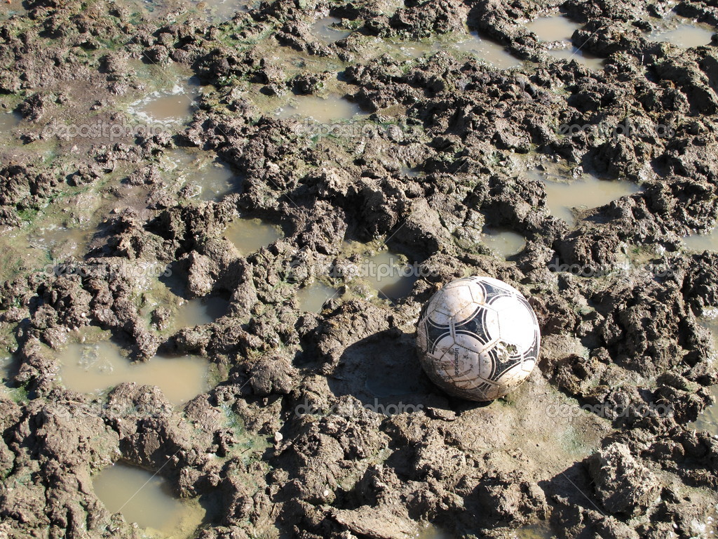A soccer ball in a field of mud — Stock Photo © FranzGustincich 21699125