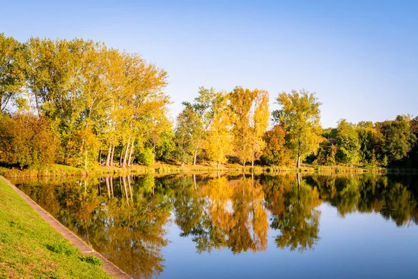 stock image Idyllic view of the fall trees reflecting in the water of a beautiful lake near Pecs, Hungary, Europe