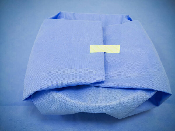 Closeup Image Of Medical Surgical Set Wrapped With Disposable Blue Drape Sheet. Selective Focus