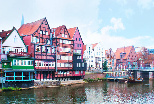 The old harbour on Ilmenau river in surrounding of half-timbered houses, Luneburg, Germany