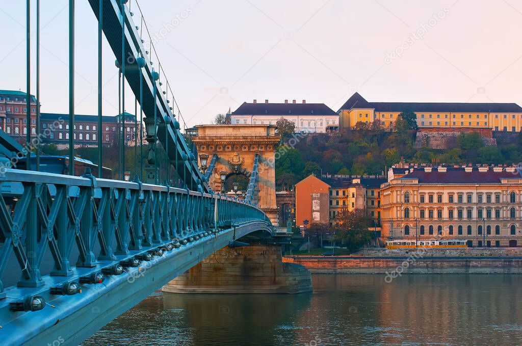 The elegant historic Szechenyi Chain Bridge across Danube River against the Buda Castle Hill, Budapest, Hungary.