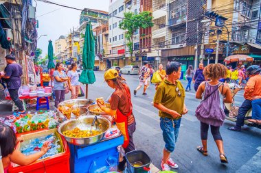 BANGKOK, THAILAND - 12 Mayıs 2019: 12 Mayıs 'ta Bangkok, Tayland' da Çin Mahallesi sokaklarında sokak yiyecekleri ve yayaların ve ulaşım araçlarının kaotik faaliyetlerinin etrafında gezinmek