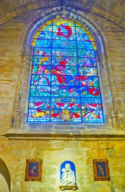 SEVILLE, SPAIN - SEPT 29, 2019: Seville Katedrali 'nin Capilla de Santiago Şapeli' nin taş duvarındaki renkli vitraylı pencere, Seville Katedrali 'nin 29 Eylül' ünde