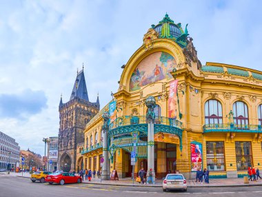 PRAGUE, CZECH REPUBLIC - 5 Mart 2022: The Art Nouveau Belediyesi (Smetana Hall), 5 Mart 'ta Prag' da Gotik Toz Kulesi 'nin arka planında sütunlar, kalıplar, heykeller ve mozaik panelle dekore edildi.