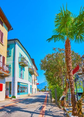 Bereketli yeşil ağaçlar, çalılar, renkli evler ve küçük restoranlar, Morcote, İsviçre 'nin manzaralı Riva da la Tor gezintinin tadını çıkarın.