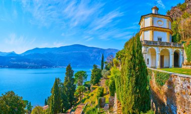 The mountain slope with beautiful terraced Scherrer Park, Oratory of St Anthony of Padua on the top and the scenic azure Lake Lugano at the foot of the mountain, Morcote, Switzerland