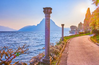 Lugano Gölü kıyısındaki Villa Heleneum Parkı 'nda romantik bir yürüyüş, İsviçre' nin muhteşem günbatımının tadını çıkarmak.