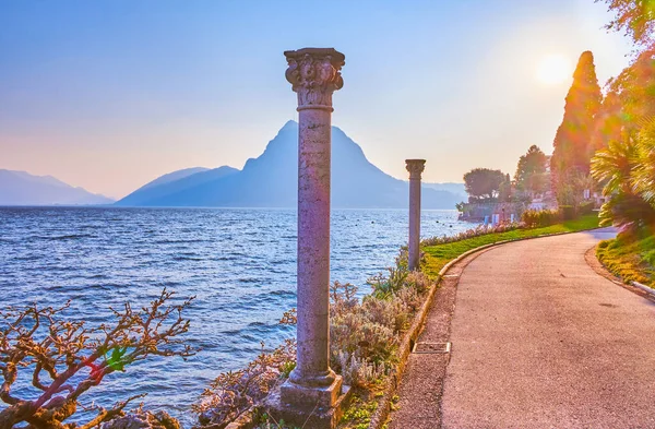 Lugano Gölü kıyısındaki Villa Heleneum Parkı 'nda romantik bir yürüyüş, İsviçre' nin muhteşem günbatımının tadını çıkarmak.