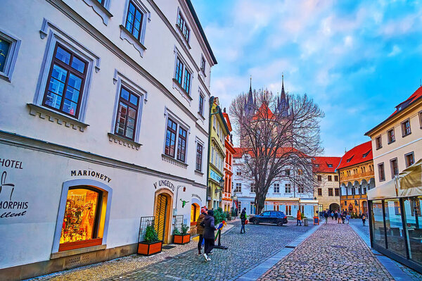 PRAGUE, CZECH REPUBLIC - MARCH 5, 2022: Tyn Yard (Tynsky Dvur) evening walk with a view of historic houses, restaurants, pubs and tourist cafes, on March 5 in Prague