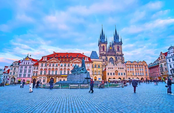 PRAGUE, CZECH REPUBLIC - MARCH 5, 2022: Panorama of the evening Old Town Square with Jan Hus Memorial and Tynsky Church belfries in the background, on March 5 in Prague