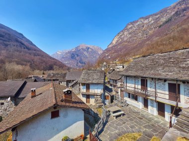 Valle Verzasca 'da bulunan ve etrafı kayalık dağlarla çevrili eski Alp köyünün taş evleri, Frasco, İsviçre