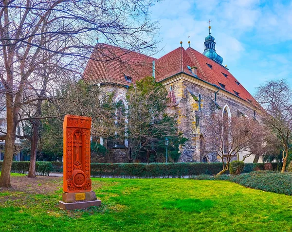 The red tuff Khachkar cross stone is a monument of Armenian-Czech Friendship, located in park next to the St Henry and St Kunhuta Church, Prague, Czech Republic