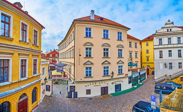 PRAGUE, CAZECH REPUBLIC - MARCH 6, 2022: The colored vintage houses of Mala Strana on Saska Street with Karel Zeman Museum and Bazar-Antik Vetesnictvi (antique market), on March 6 in Prague