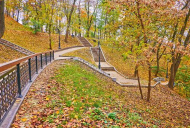 The steep slopes of St Volodymyr Hill park, covered with yellow autumn foliage, Kyiv, Ukraine