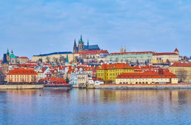 The medieval Prague Castle with Gothic St Vitus Cathedral, dominating the skyline, with Vltava River in the foreground, Prague, Czech Republic