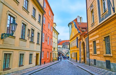 Walk down the narrow street of Mala Strana (Lesser Quarter), lined with beautiful colored houses with museums, restaurants and hotels, Prague, Czech Republic