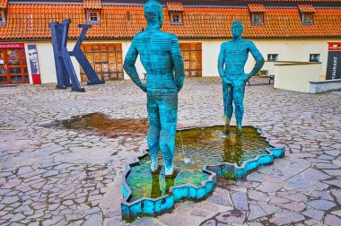 PRAGUE, CZECH REPUBLIC - MARCH 6, 2022:   The unique Piss statue by David Cerny, located in Lesser Quarter (Mala Strana) in front of Franz Kafka Museum, on March 6 in Prague