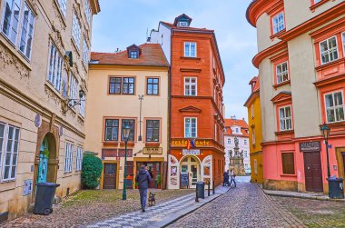 PRAGUE, CZECH REPUBLIC - MARCH 6, 2022: The narrow cobblestone alley amid the vintage houses of Prokopska Street, Lesser Quarter, on March 6 in Prague